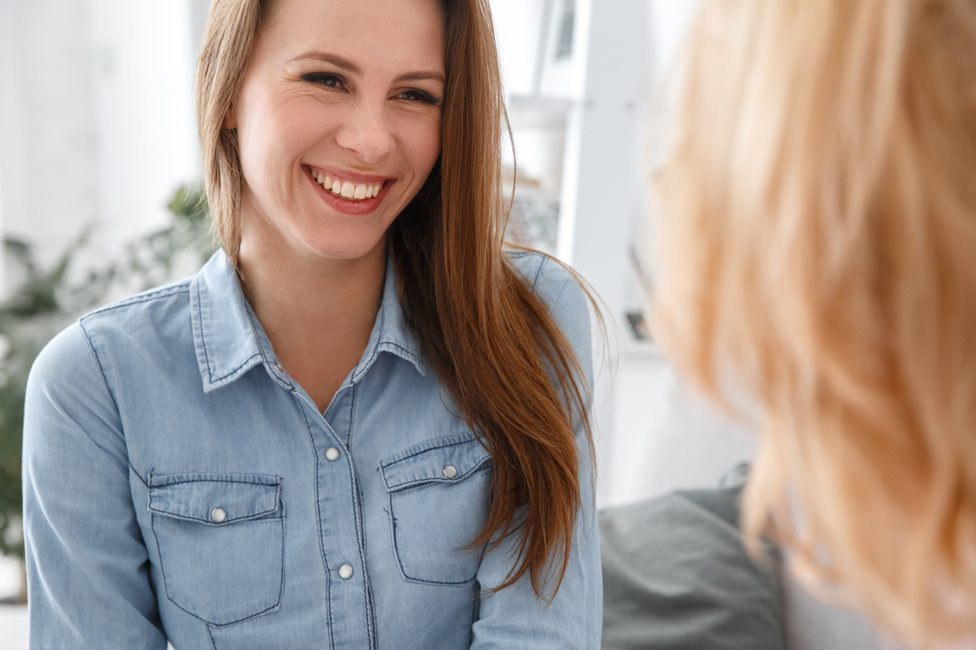 Young women smiling at another women